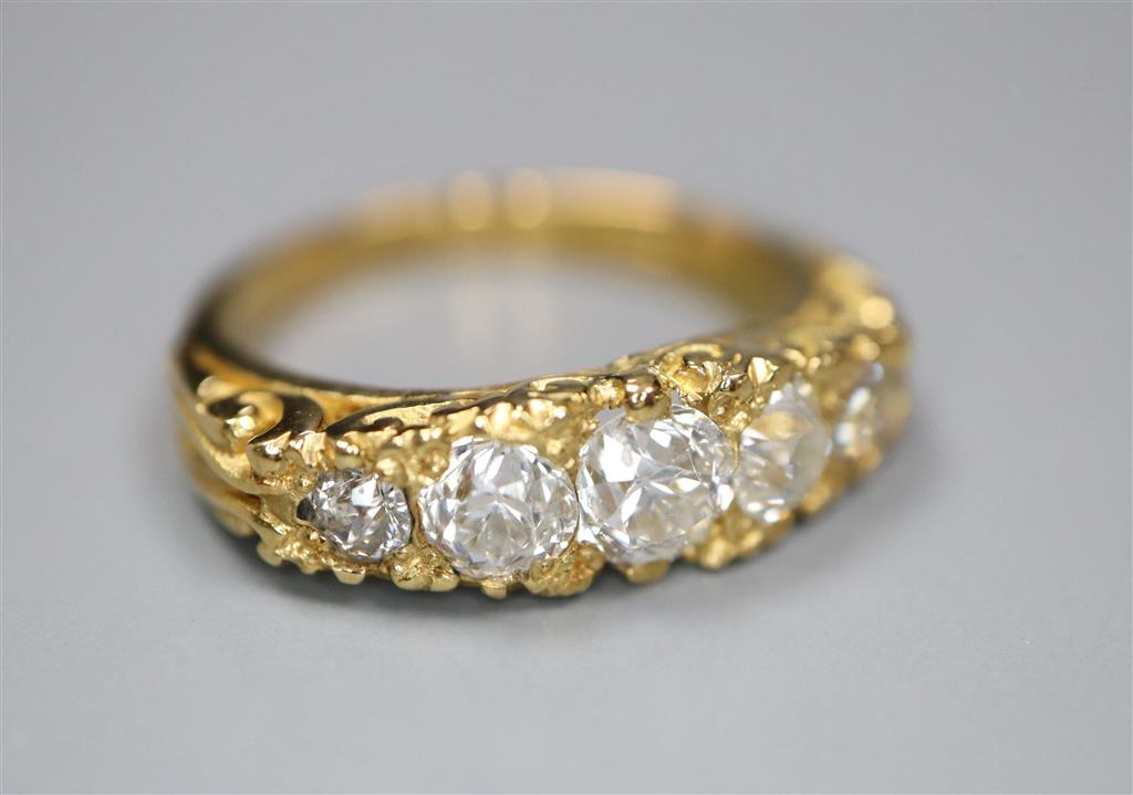 A modern Victorian style 18ct gold and graduated old round cut diamond set half hoop ring,